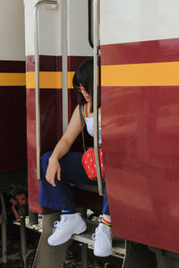 Rear view of woman standing by train