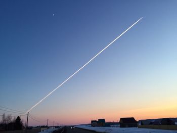 Vapor trail against clear blue sky