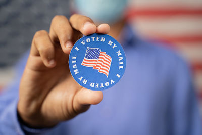 Close-up of hand holding flag