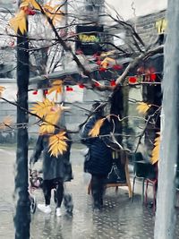 People walking on wet street during rainy season