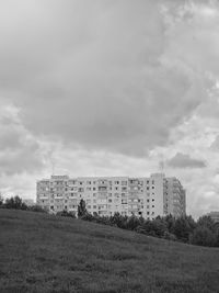 Buildings on field against sky