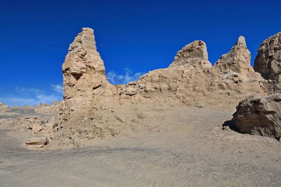 Rock formations against clear blue sky