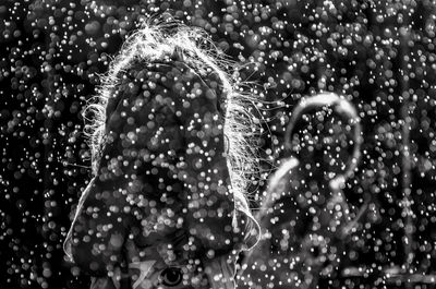 Little girl covering her face in snow