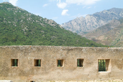 House and mountains against sky