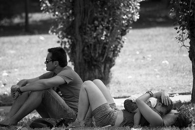 Rear view of woman sitting on bench