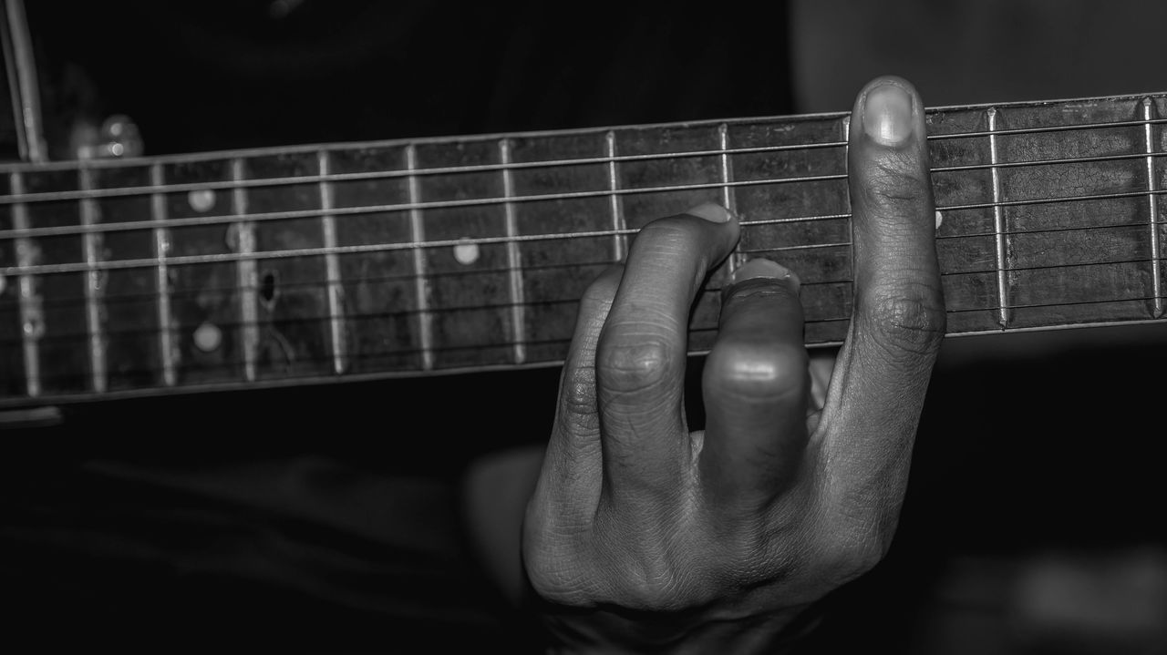 MAN PLAYING GUITAR ON STAGE