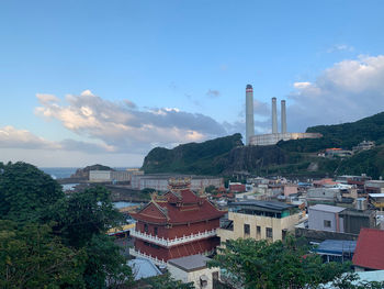 Buildings in city against sky