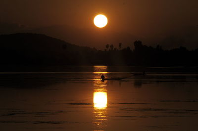 Scenic view of lake against sky during sunset