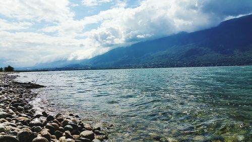 Scenic view of sea against cloudy sky