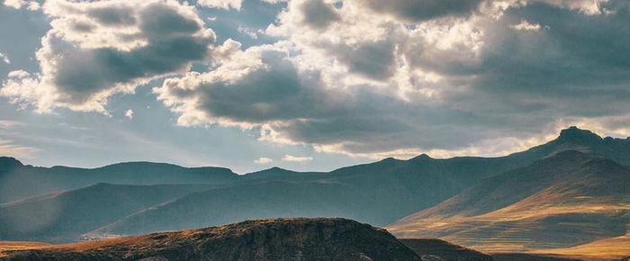 Panoramic view of mountains against cloudy sky