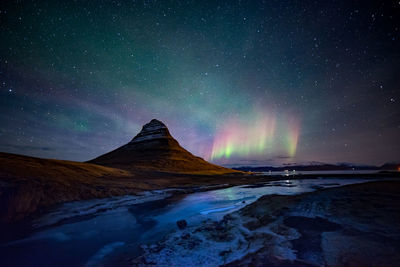 Scenic view of mountains against sky at night