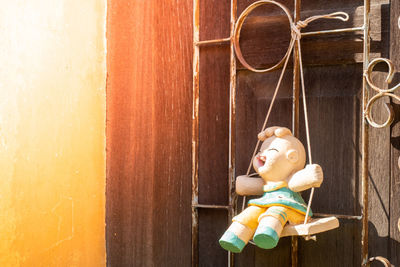 Full length of boy with toy on door