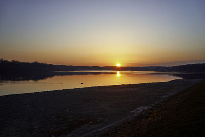 Scenic view of lake against sky during sunset