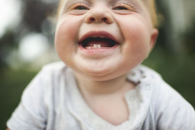 Close-up of cheerful baby boy outdoors