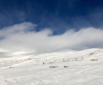 Scenic view of snow covered mountains against sky