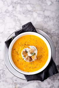 Directly above shot soup served in bowl on table