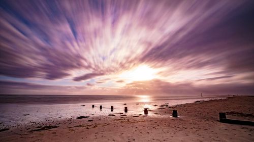 Scenic view of beach against sky during sunset