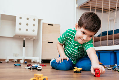 Boy playing with toy car at home