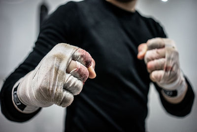 Midsection of boxer with bandages in fighting stance