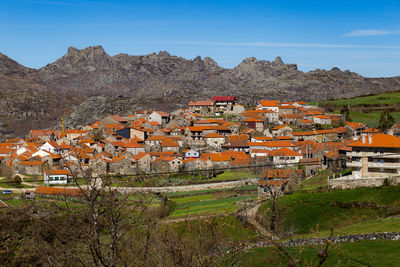 Houses in town against sky