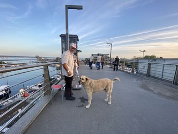 Old man on the bridge and his  dog 