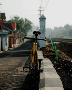 Bicycle on street amidst buildings in city