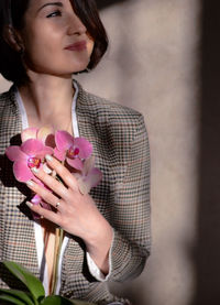 Young woman holding flower