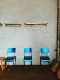 Empty chairs against wall