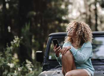 Young woman sitting in car