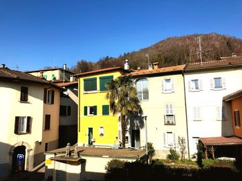 Residential buildings against clear blue sky