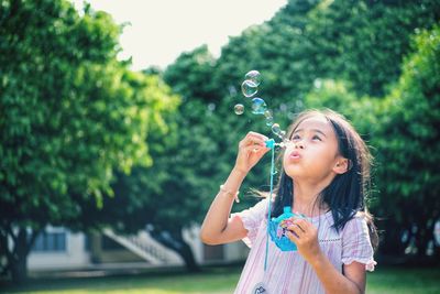 Portrait of a girl holding bubbles