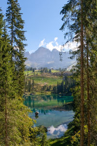 Scenic view of lake and mountains traveling through the dolomites, italy 