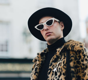 Portrait of mature man wearing sunglasses standing outdoors