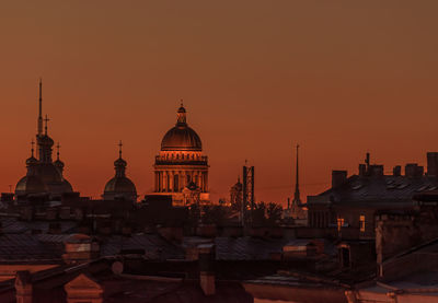 View of buildings against clear sky at sunset