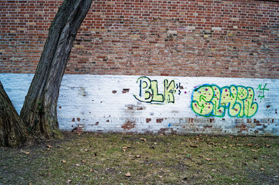 Close-up of text on brick wall