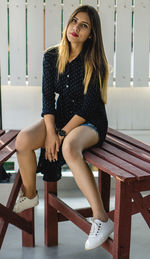 Portrait of young woman sitting on seat