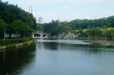 Scenic view of lake by trees against sky