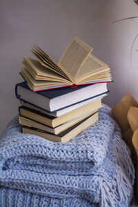 Close-up of books on table against wall