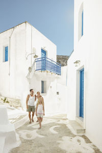 Rear view of people walking on building