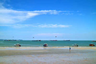 People on beach against sky