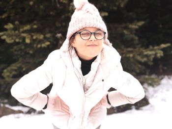 Portrait of girl standing in warm clothing on field during winter