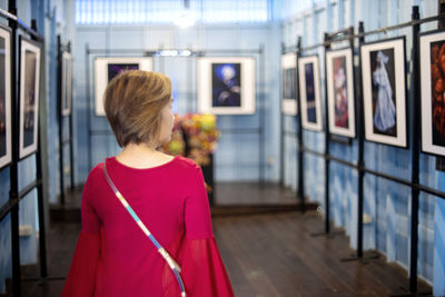 Rear view of woman standing in corridor