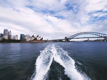 View of bridge over sea against cloudy sky