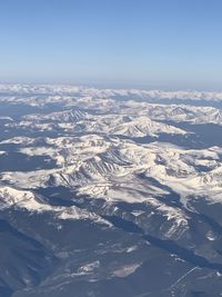 Aerial view of snowcapped mountains against sky