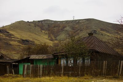 Houses on landscape against sky