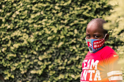 A portrait of a boy wearing mask looking at camera