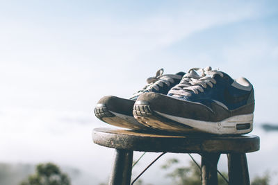 Low angle view of shoes on wood against sky