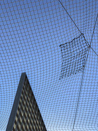 Metal net with sky in background