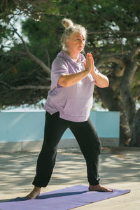 Portrait of young woman exercising in park