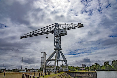 Low angle view of crane against sky